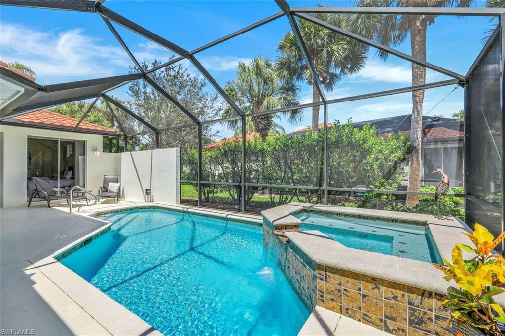 10215 Cape Roman Road, Unit 101 Estero, FL 34135 - Photo 1 of 50 a swimming pool with outdoor seating and yard