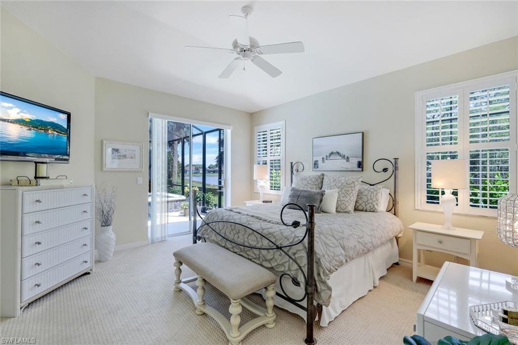 10215 Cape Roman Road, Unit 101 Estero, FL 34135 - Photo 14 of 50 a bedroom with a bed and a flat screen tv