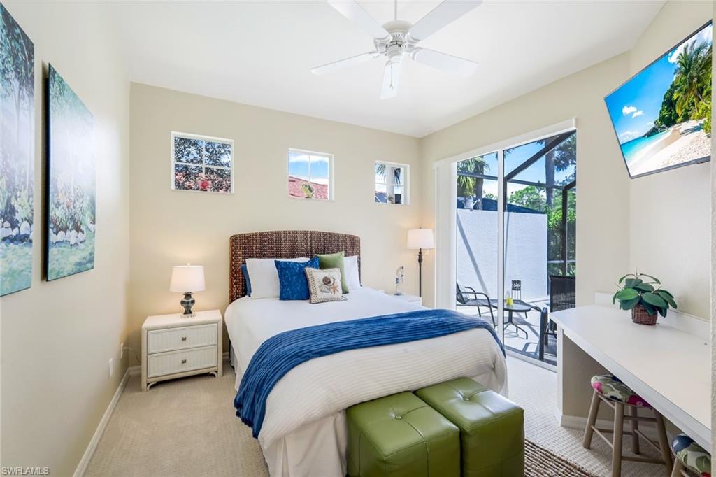 10215 Cape Roman Road, Unit 101 Estero, FL 34135 - Photo 18 of 50 a bedroom with a bed a couch and a window