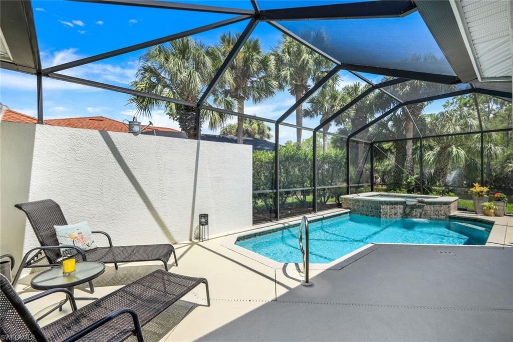 10215 Cape Roman Road, Unit 101 Estero, FL 34135 - Photo 21 of 50 a view of a patio with a table and chairs