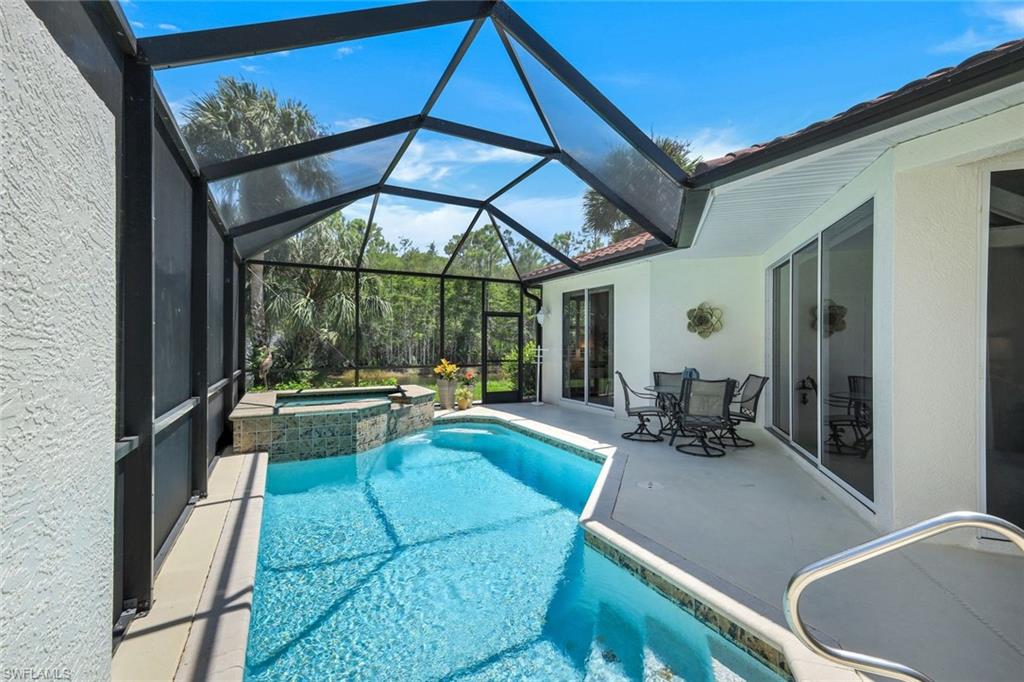 10215 Cape Roman Road, Unit 101 Estero, FL 34135 - Photo 23 of 50 a view of swimming pool with outdoor seating