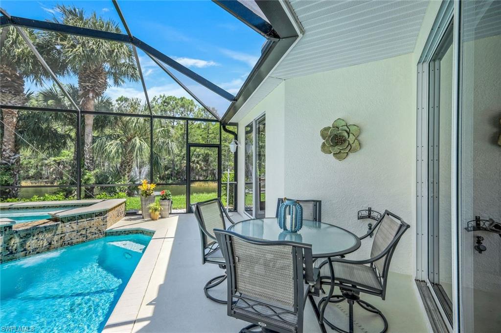 10215 Cape Roman Road, Unit 101 Estero, FL 34135 - Photo 24 of 50 a view of a dining room with furniture window and outside view