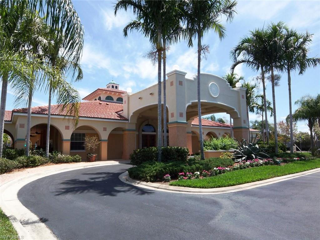 10215 Cape Roman Road, Unit 101 Estero, FL 34135 - Photo 33 of 50 a front view of multi story residential apartment building with yard and green space