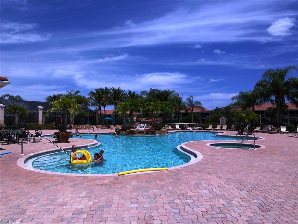 10215 Cape Roman Road, Unit 101 Estero, FL 34135 - Photo 36 of 50 a view of a swimming pool and lounge chair