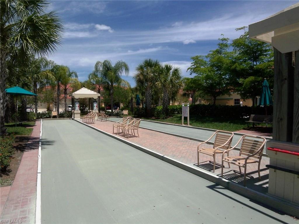 10215 Cape Roman Road, Unit 101 Estero, FL 34135 - Photo 38 of 50 a view of a swimming pool with a lounge chair