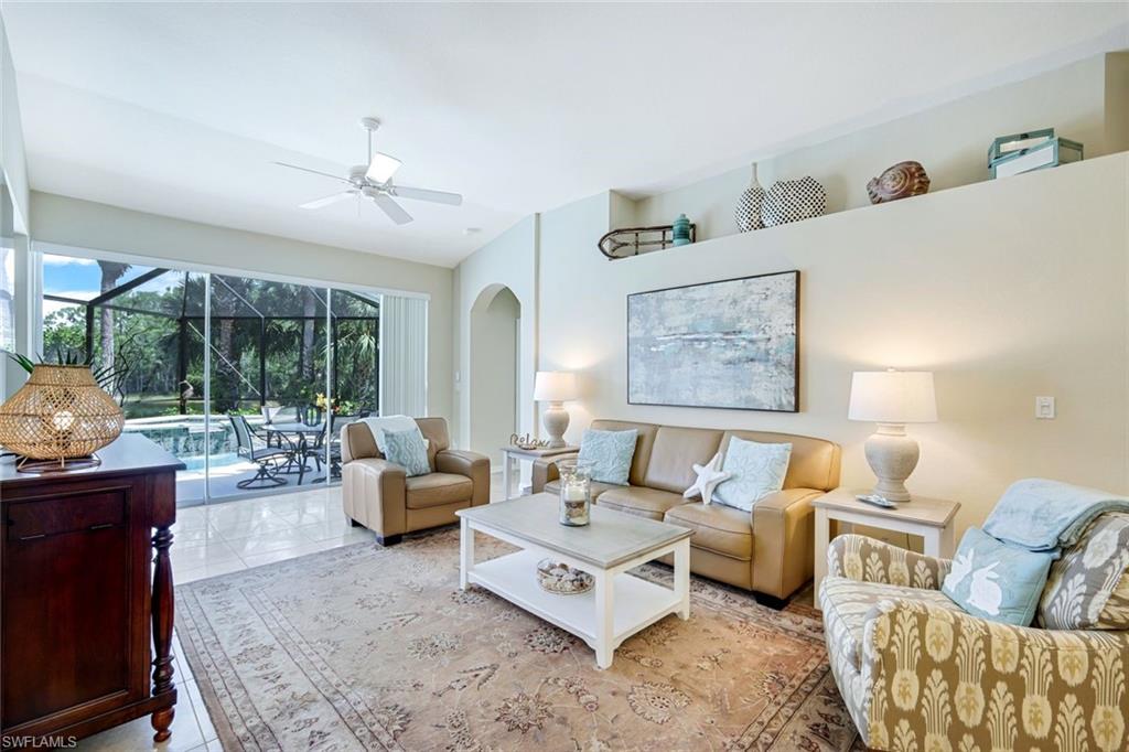10215 Cape Roman Road, Unit 101 Estero, FL 34135 - Photo 4 of 50 a living room with furniture rug and large window