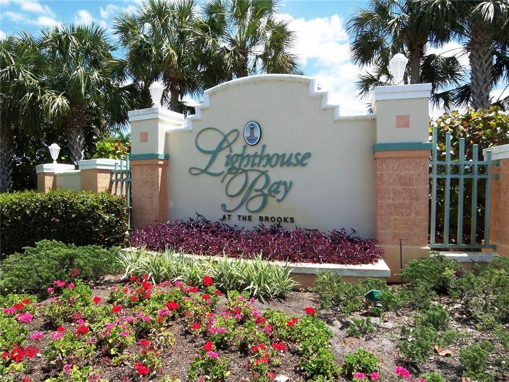 10215 Cape Roman Road, Unit 101 Estero, FL 34135 - Photo 41 of 50 a sign that is in front of flowers