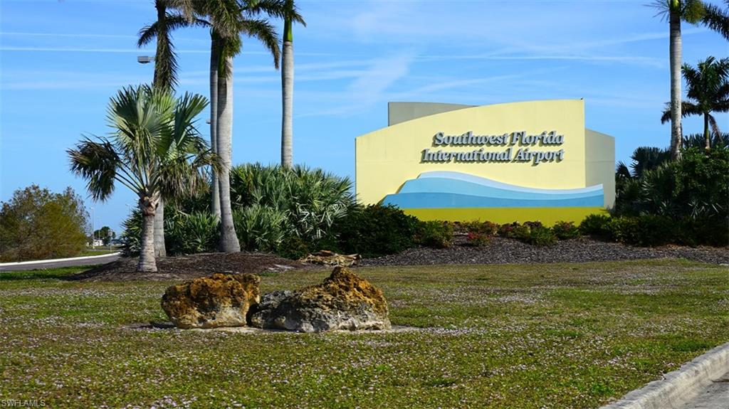 10215 Cape Roman Road, Unit 101 Estero, FL 34135 - Photo 47 of 50 a view of swimming pool with a yard and palm trees