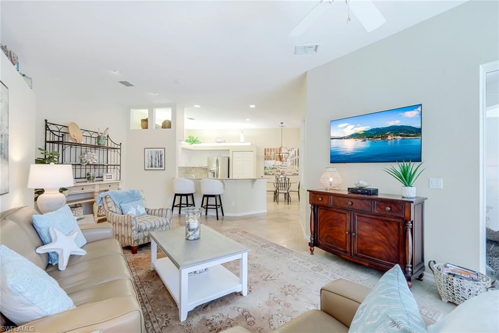 10215 Cape Roman Road, Unit 101 Estero, FL 34135 - Photo 7 of 50 a living room with furniture and a flat screen tv