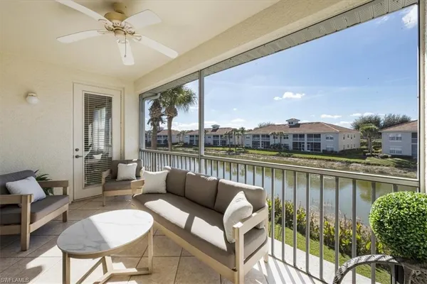 a balcony with furniture and a lake view