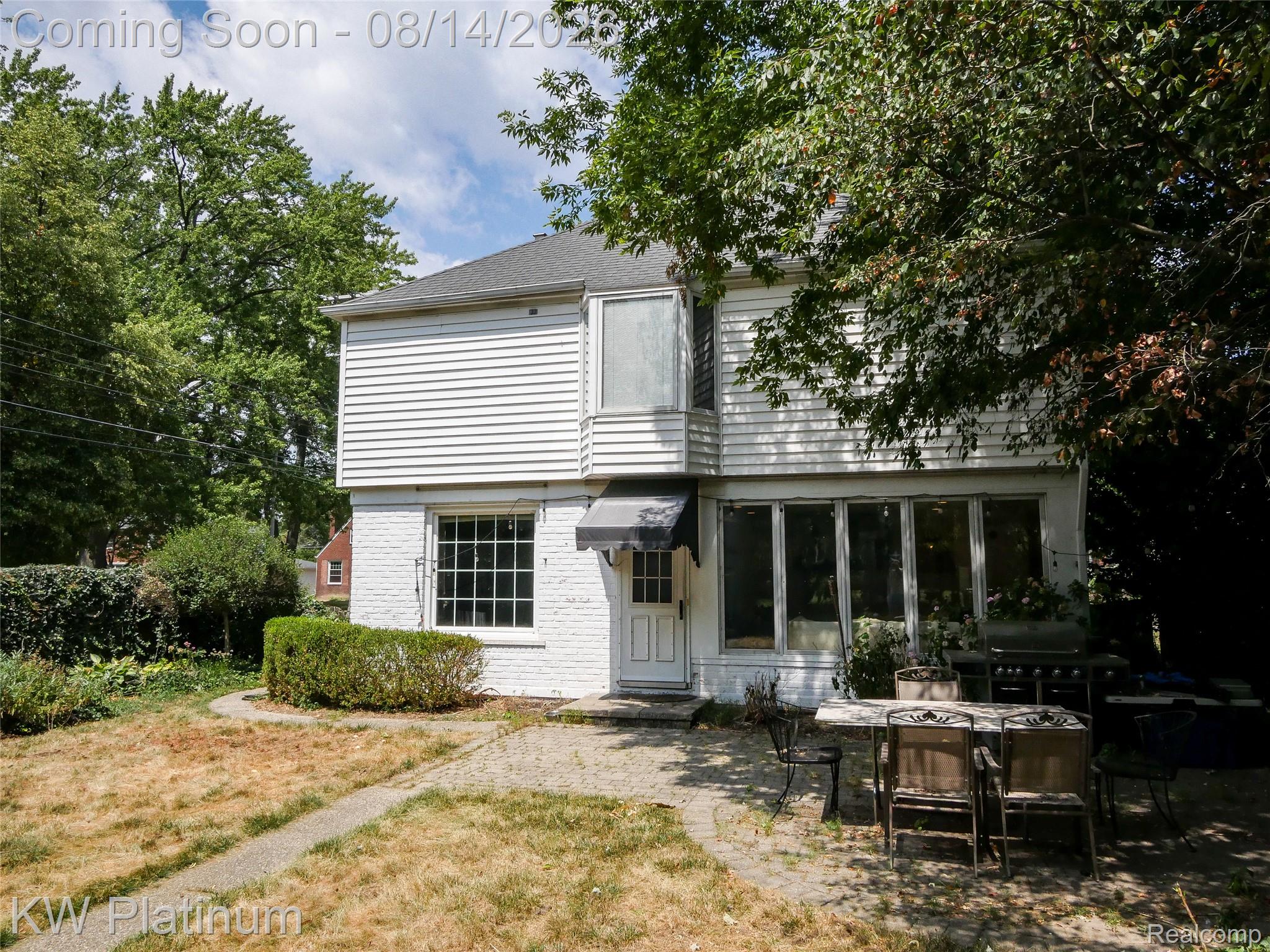 657 Hawthorne Road Grosse Pointe, MI 48236 - Photo 23 of 28 White siding and brick exterior featuring multiple window styles