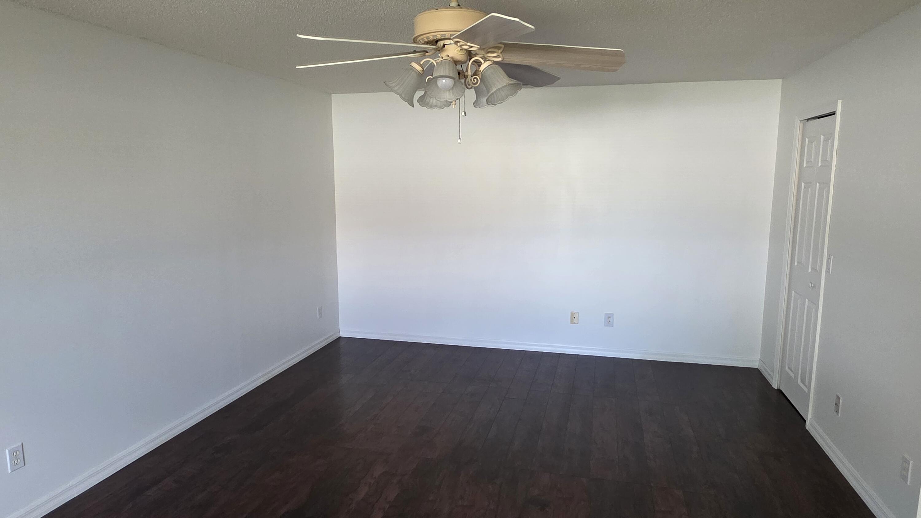 6448 Northwest Colgate Street Port St. Lucie, FL 34986 - Photo 13 of 21 an empty room with a fan and a ceiling fan
