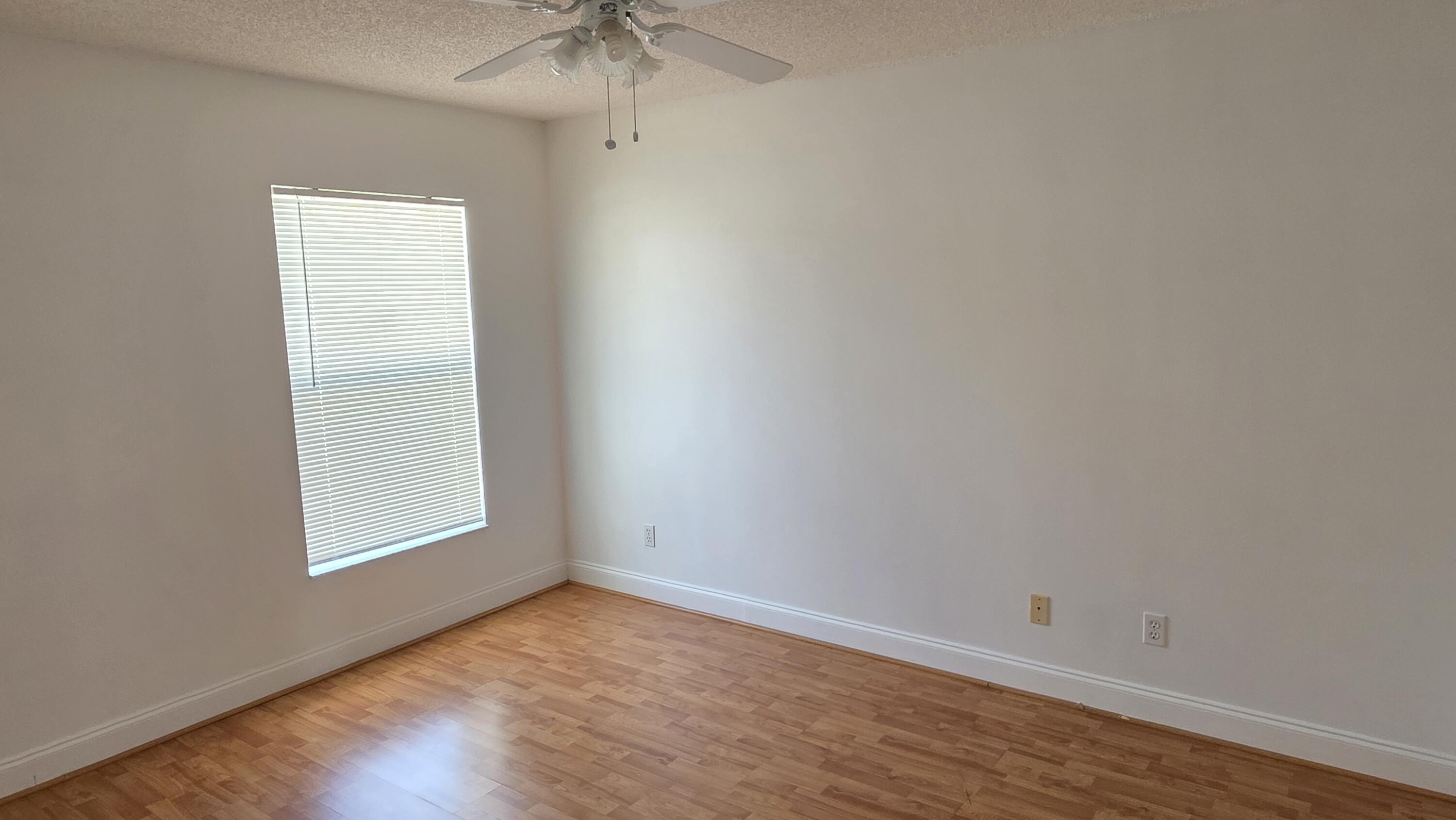 6448 Northwest Colgate Street Port St. Lucie, FL 34986 - Photo 18 of 21 an empty room with a window and a fan