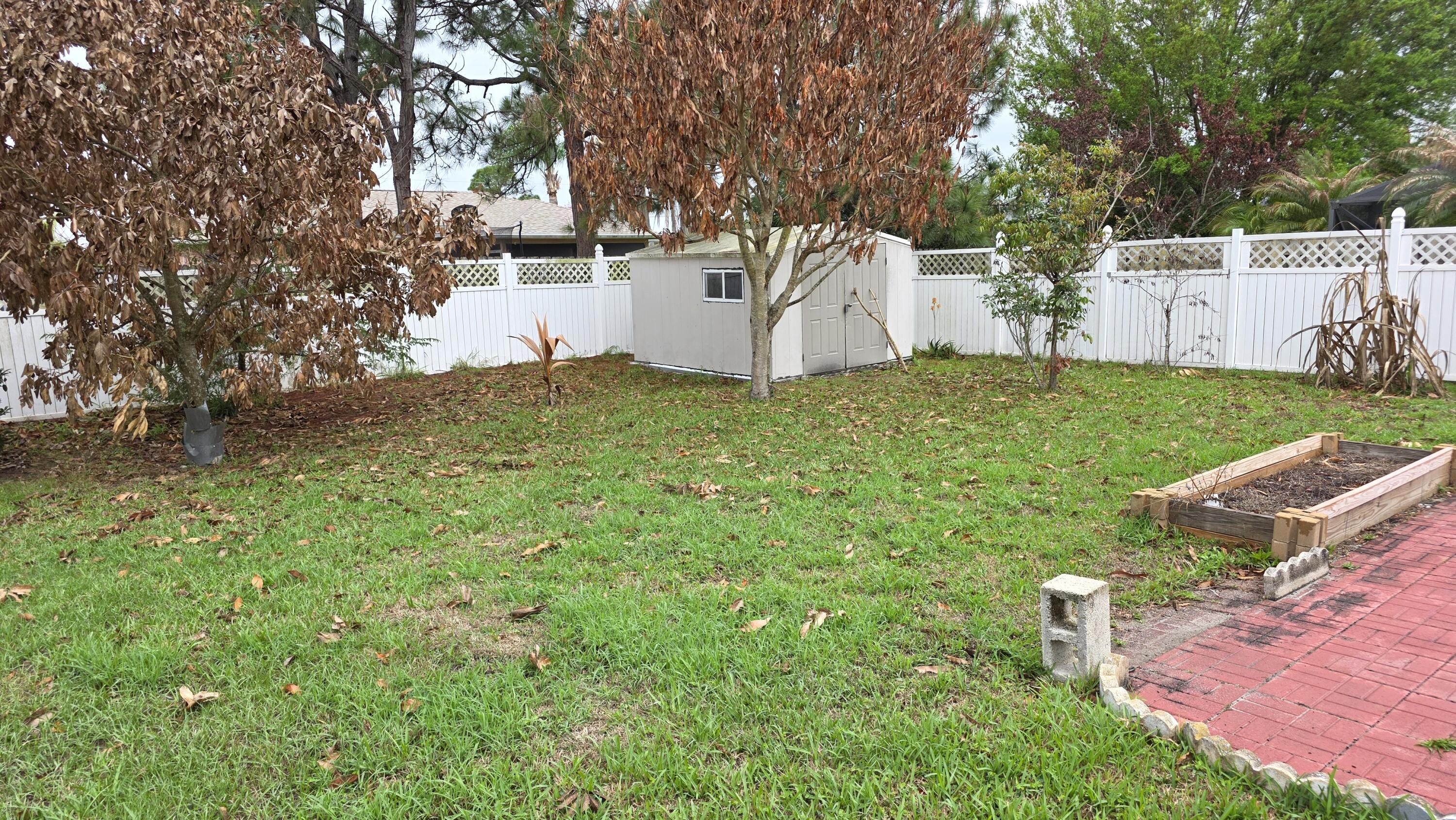 6448 Northwest Colgate Street Port St. Lucie, FL 34986 - Photo 20 of 21 a view of a backyard