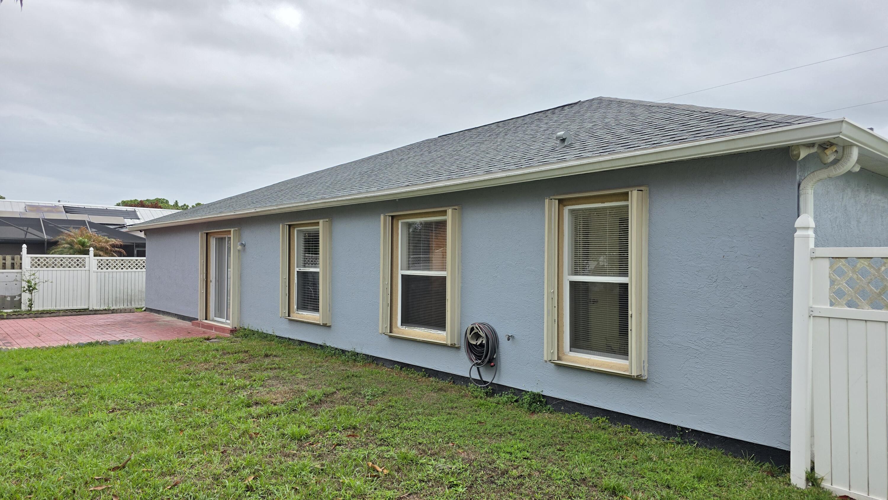 6448 Northwest Colgate Street Port St. Lucie, FL 34986 - Photo 2 of 21 a backyard of a house with table and chairs