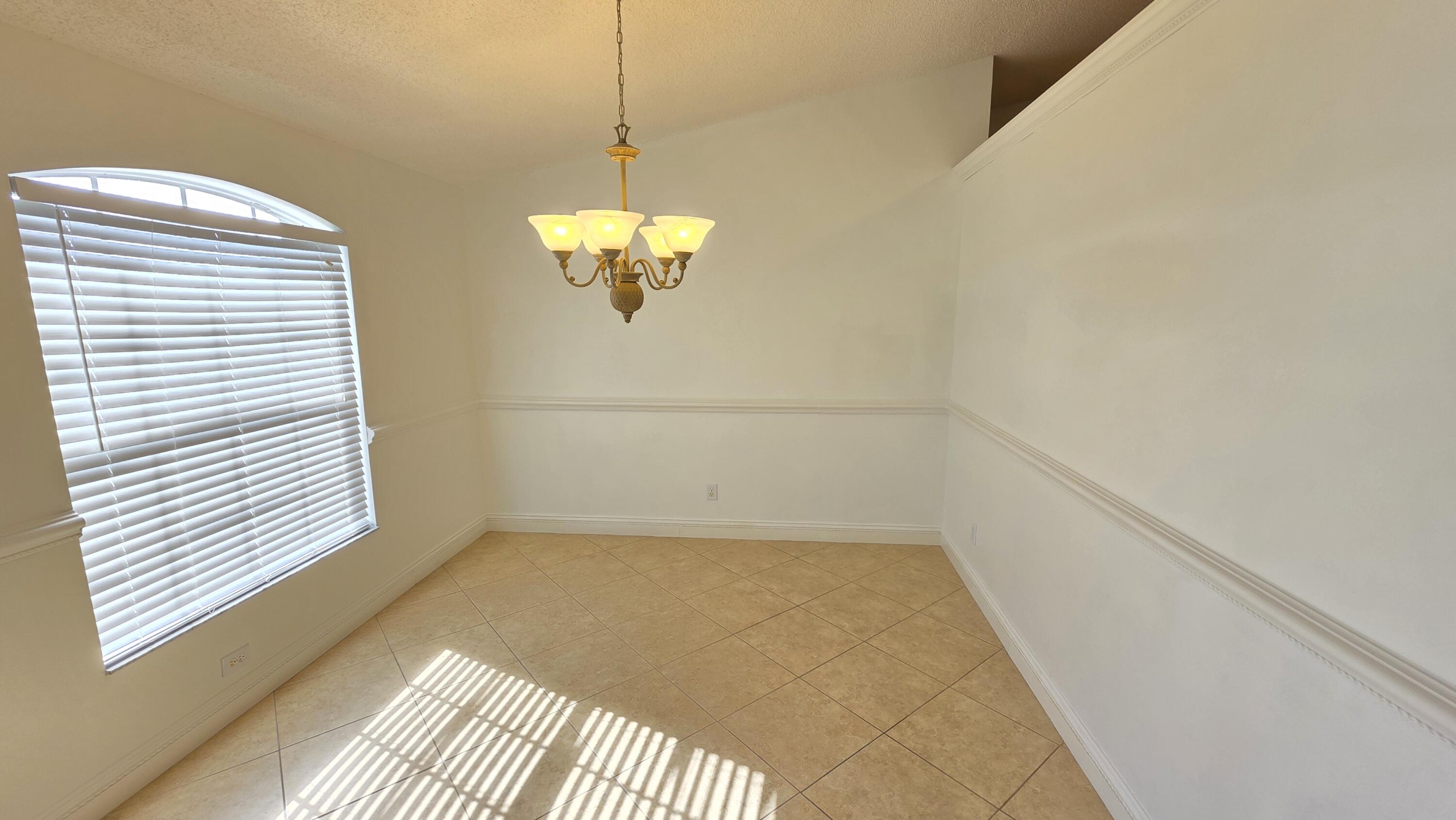 6448 Northwest Colgate Street Port St. Lucie, FL 34986 - Photo 3 of 21 a view of a room with a chandelier