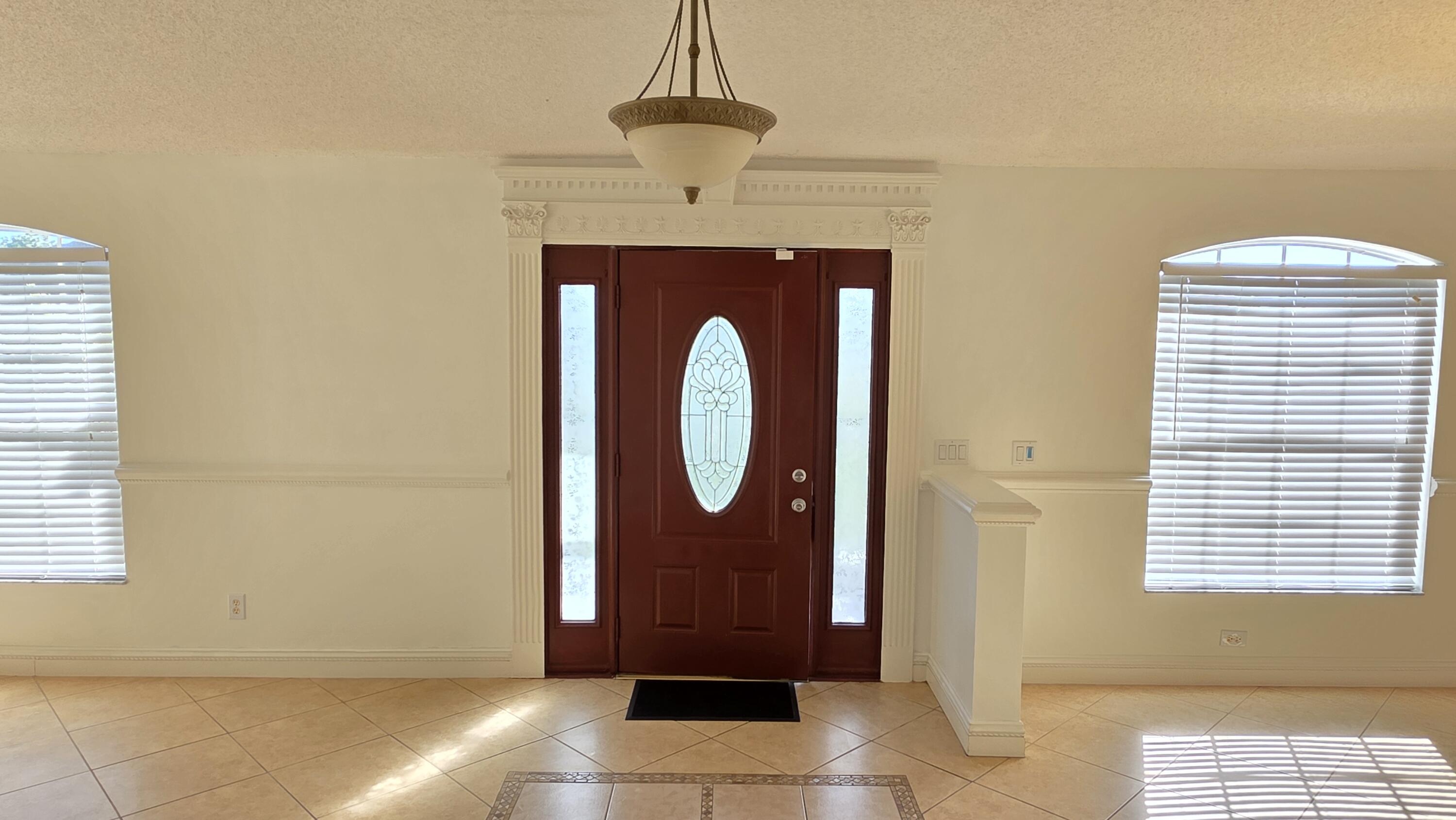 6448 Northwest Colgate Street Port St. Lucie, FL 34986 - Photo 5 of 21 a front view of a house with entryway