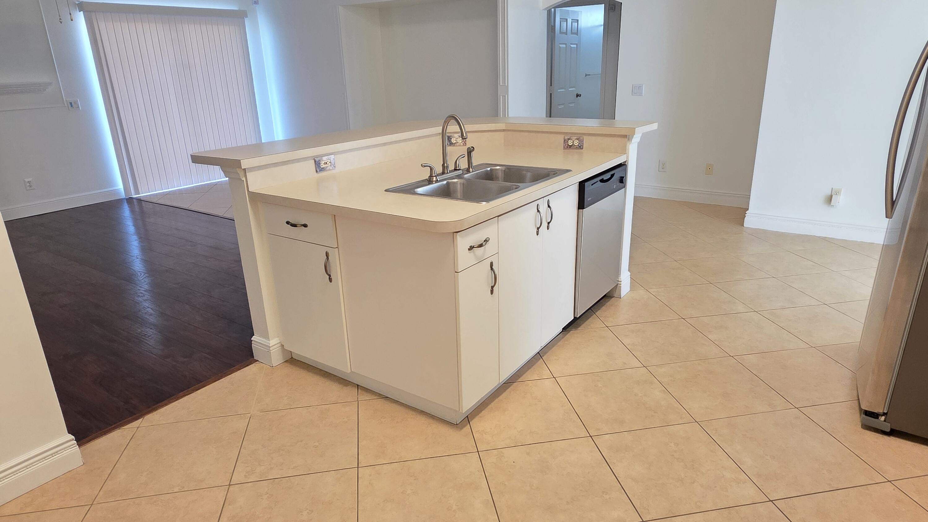 6448 Northwest Colgate Street Port St. Lucie, FL 34986 - Photo 8 of 21 a utility room with a sink a vanity and a mirror