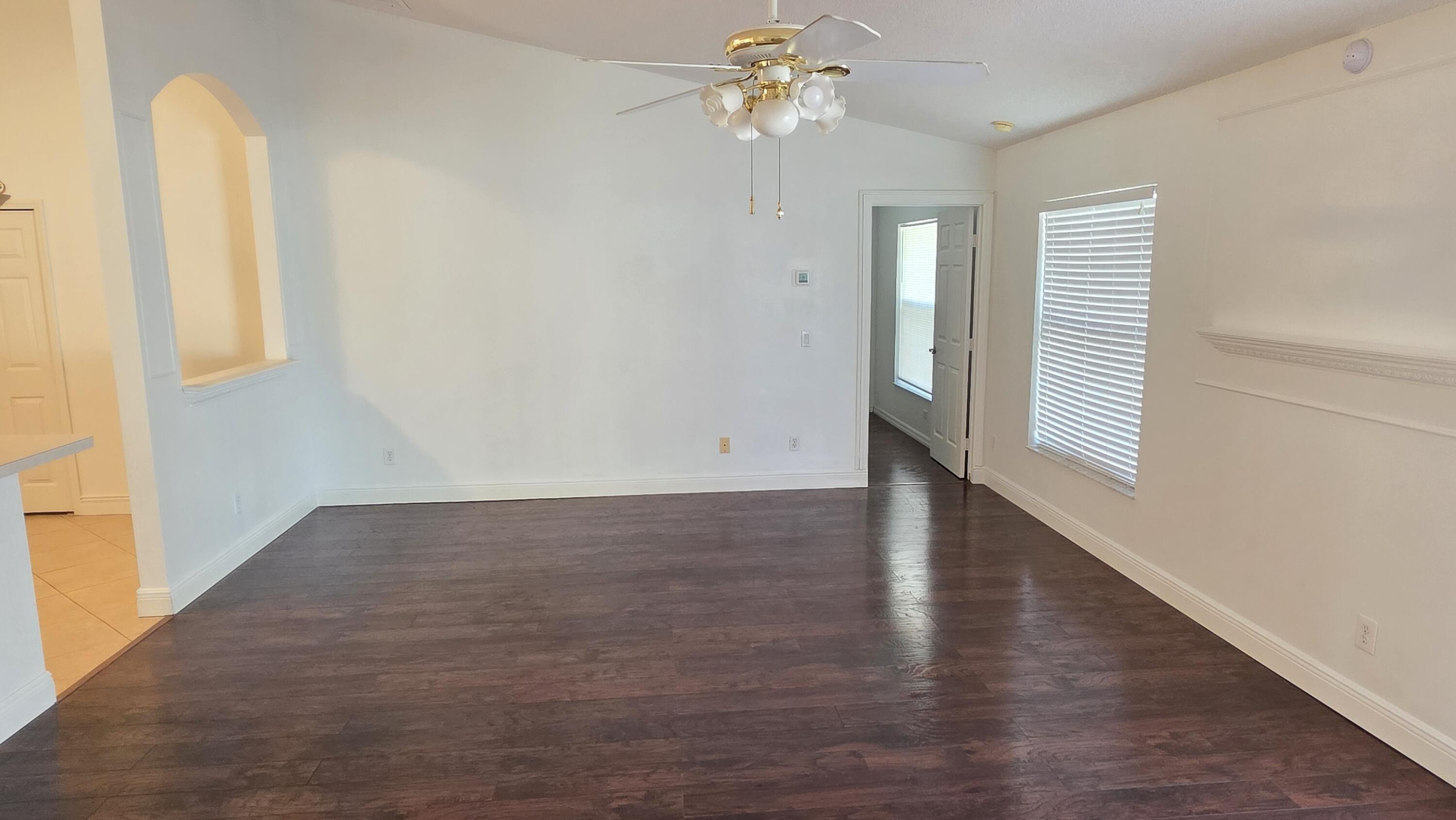 6448 Northwest Colgate Street Port St. Lucie, FL 34986 - Photo 10 of 21 wooden floor in an empty room with a window