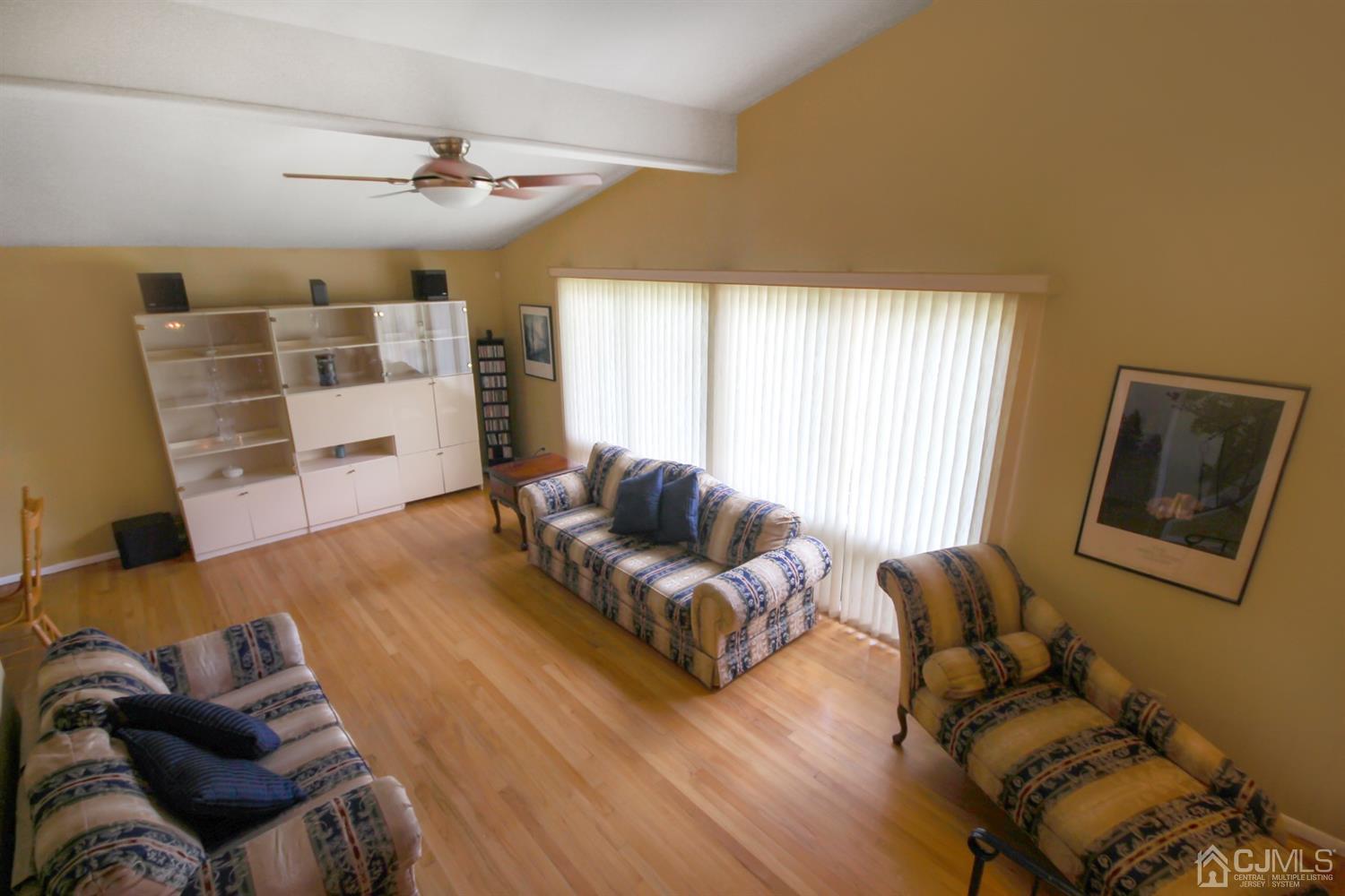 22 Bruning Road East Brunswick, NJ 08816 - Photo 11 of 31 a living room with furniture and a flat screen tv
