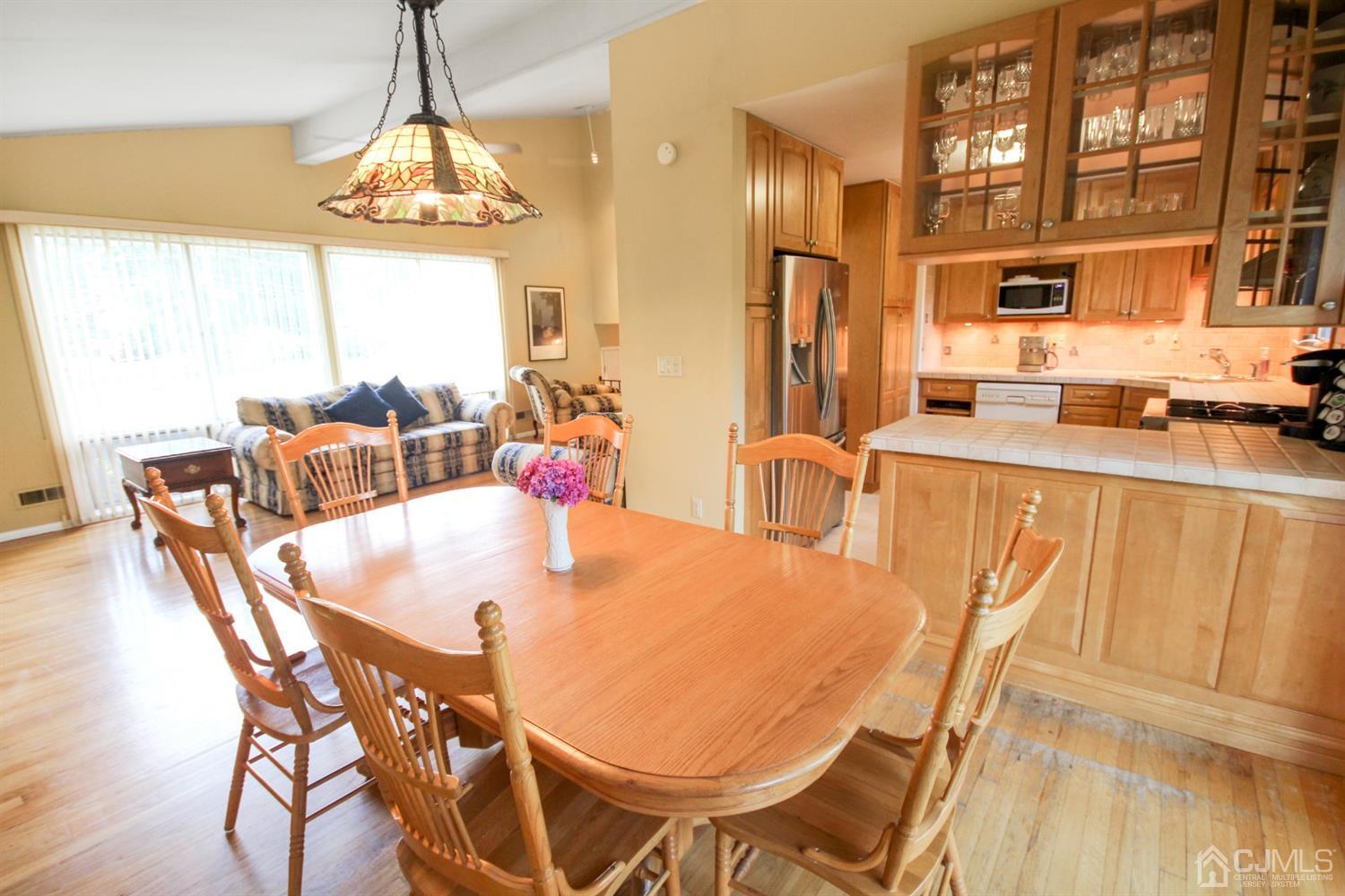 22 Bruning Road East Brunswick, NJ 08816 - Photo 14 of 31 a view of a dining room with furniture a chandelier and wooden floor
