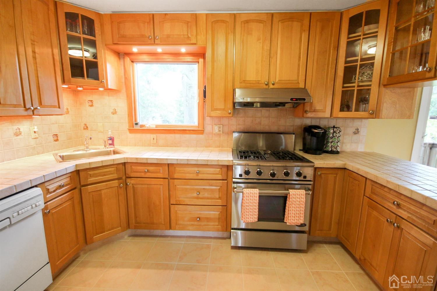 22 Bruning Road East Brunswick, NJ 08816 - Photo 17 of 31 a kitchen with stainless steel appliances granite countertop a stove a sink and a microwave
