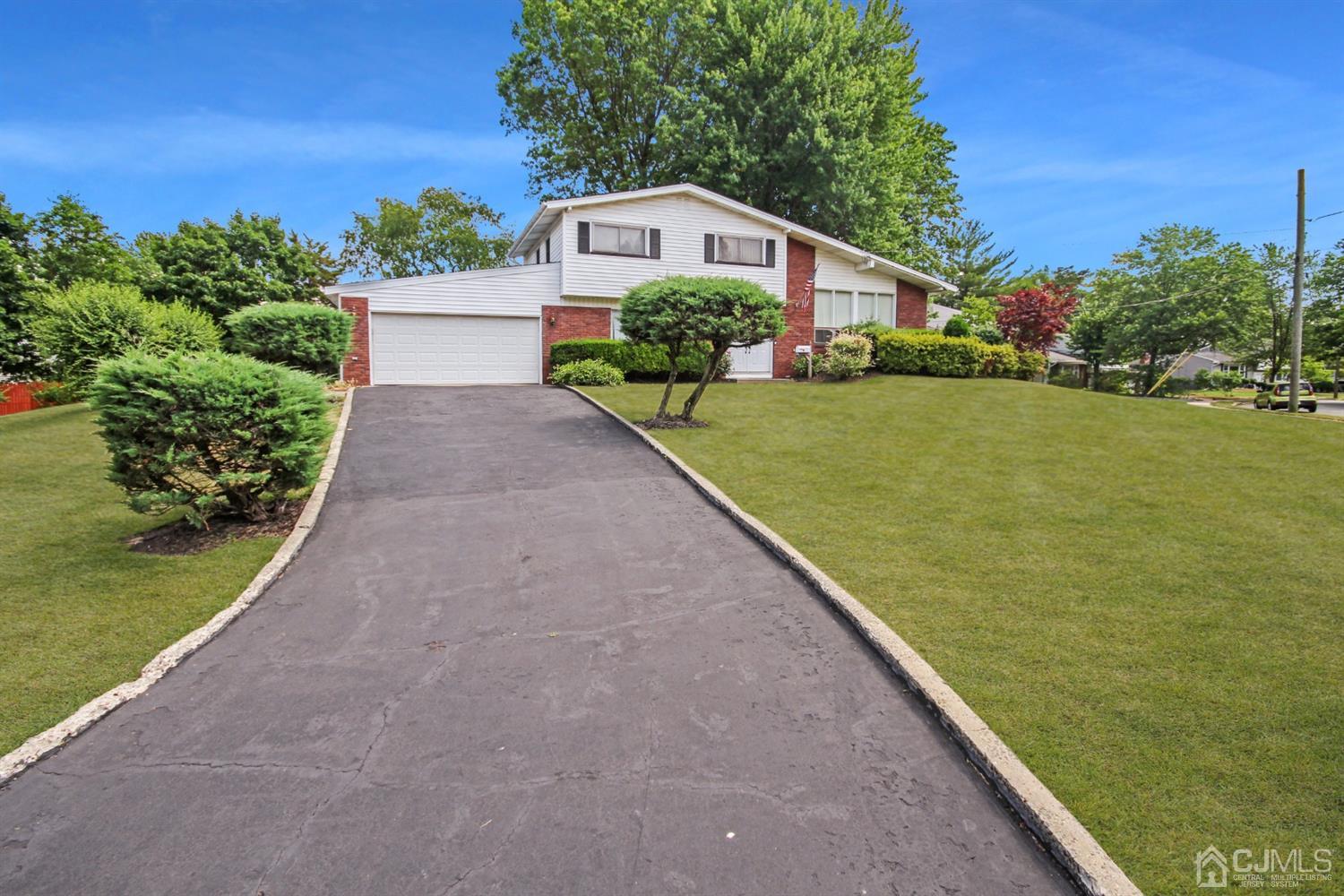22 Bruning Road East Brunswick, NJ 08816 - Photo 3 of 31 a front view of a house with a yard and potted plants