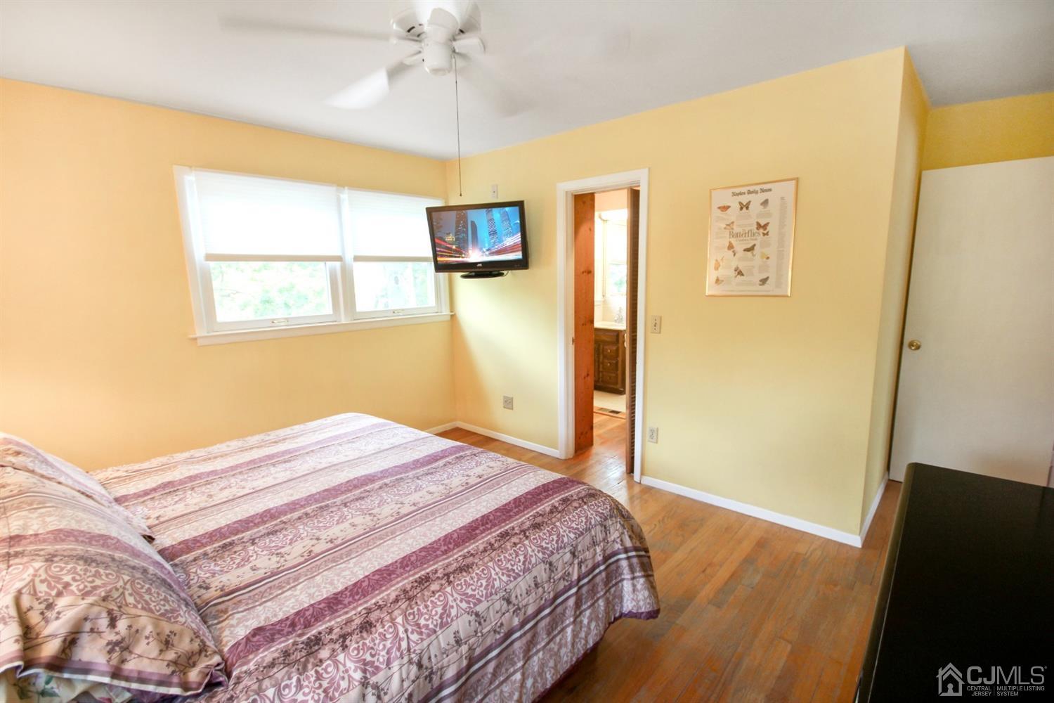 22 Bruning Road East Brunswick, NJ 08816 - Photo 21 of 31 a bedroom with a bed and wooden floor