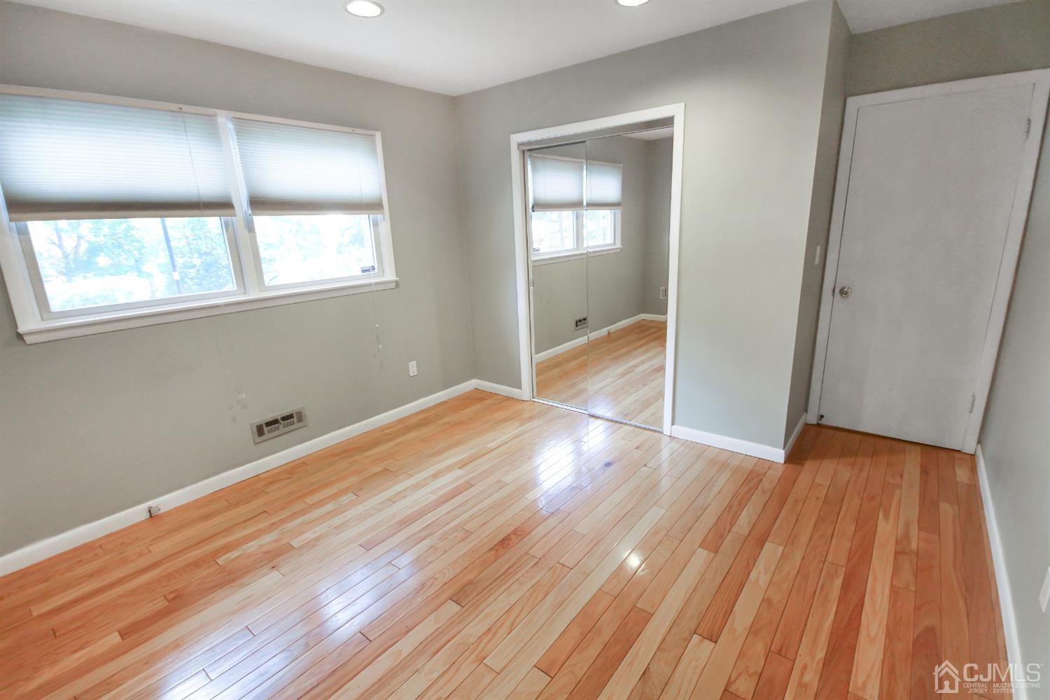 22 Bruning Road East Brunswick, NJ 08816 - Photo 31 of 31 an empty room with wooden floor and windows