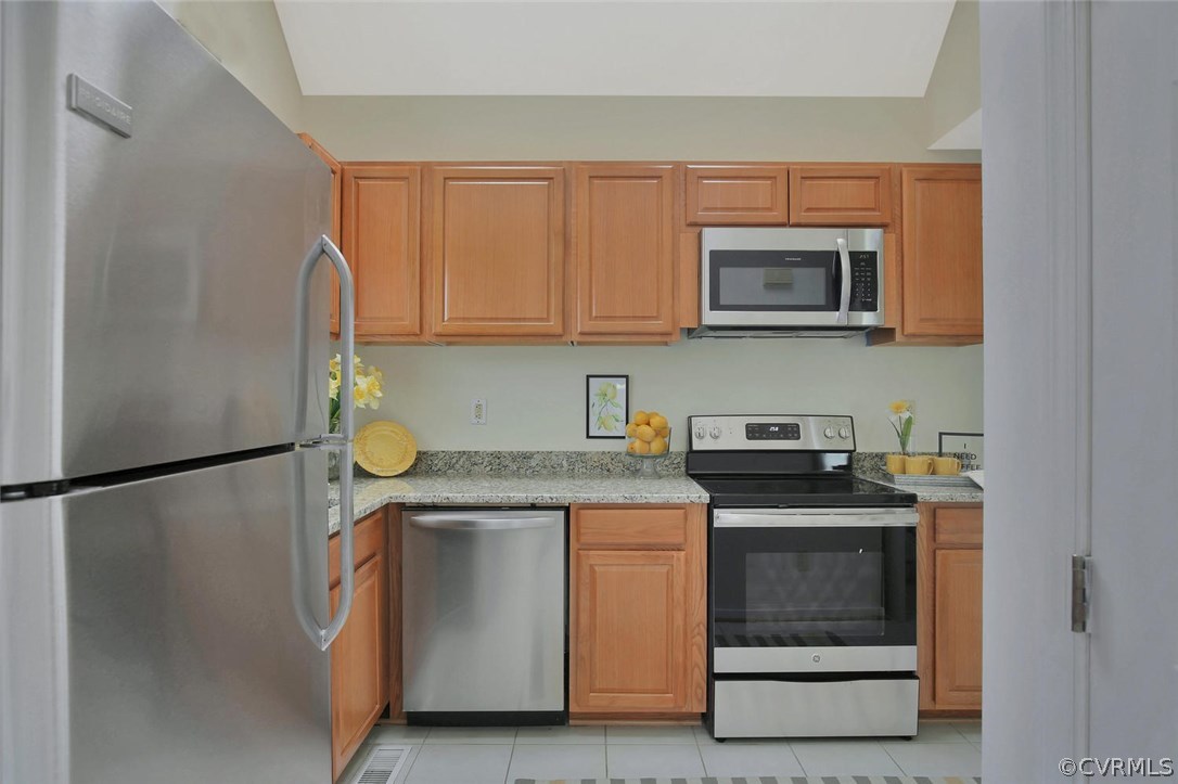 4732 Cedar Cliff Road Chester, VA 23831 - Photo 12 of 25 a kitchen with stainless steel appliances granite countertop a refrigerator a stove a sink and a microwave