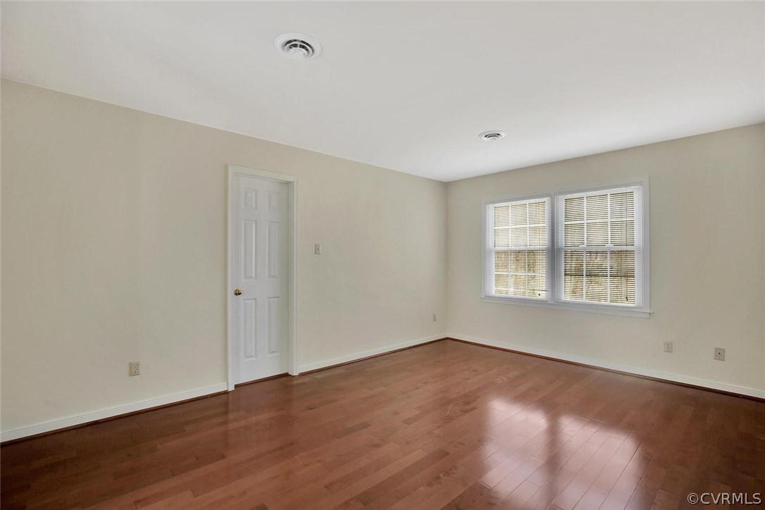 4732 Cedar Cliff Road Chester, VA 23831 - Photo 15 of 25 a view of an empty room with wooden floor and a window