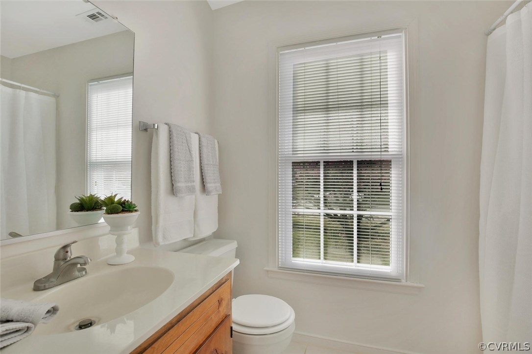 4732 Cedar Cliff Road Chester, VA 23831 - Photo 17 of 25 a bathroom with a sink toilet a mirror and shower