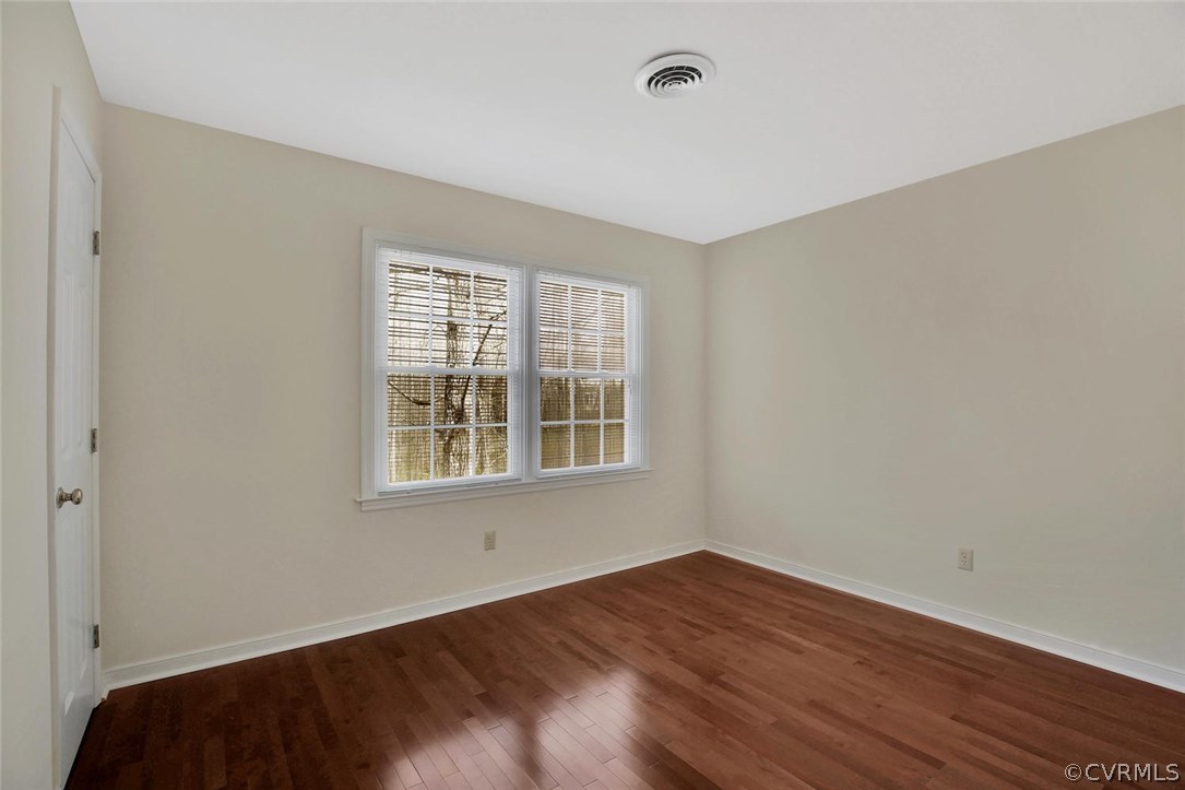 4732 Cedar Cliff Road Chester, VA 23831 - Photo 20 of 25 a view of an empty room with wooden floor and a window