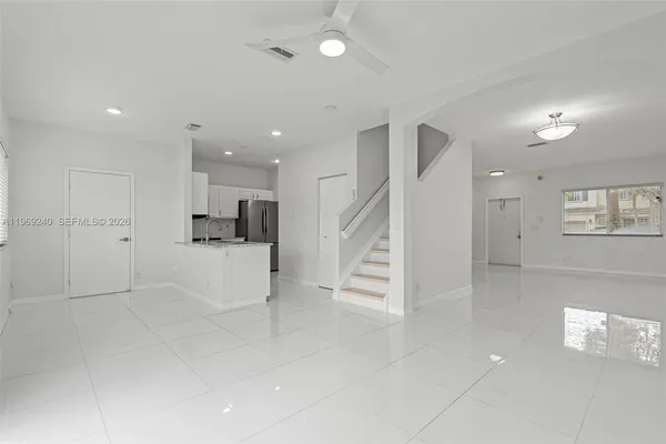 a view of kitchen with furniture and refrigerator