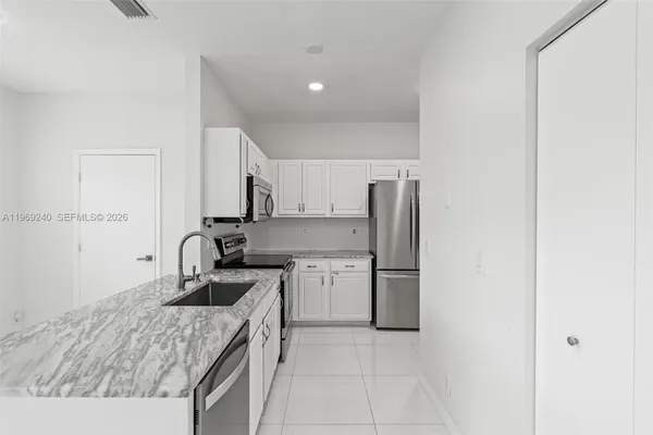 a kitchen with a sink and refrigerator