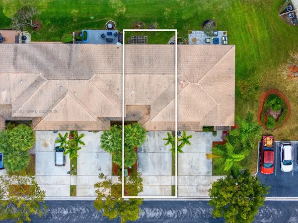 an aerial view of a house with a swimming pool outdoor seating and yard