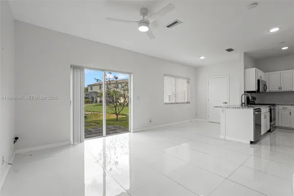 a view of kitchen with furniture and large window