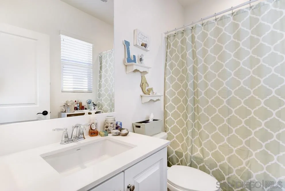 3684 Tavara Circle San Diego, CA 92117 - Photo 12 of 22 a bathroom with a sink and a mirror