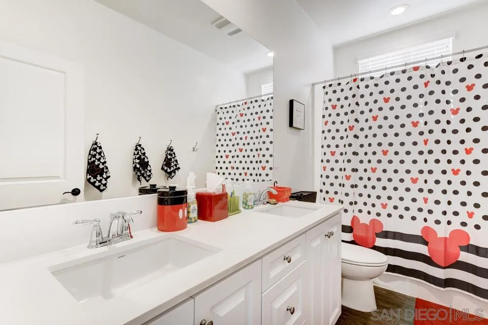 3684 Tavara Circle San Diego, CA 92117 - Photo 14 of 22 a bathroom with a sink toilet and a shower