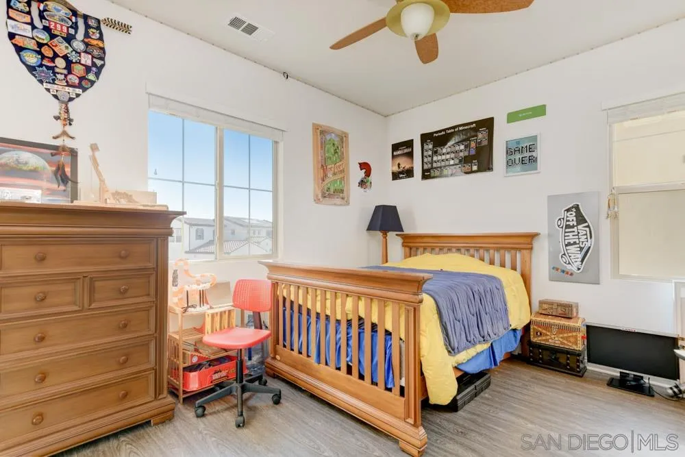 3684 Tavara Circle San Diego, CA 92117 - Photo 15 of 22 a bedroom with a bed and a chandelier