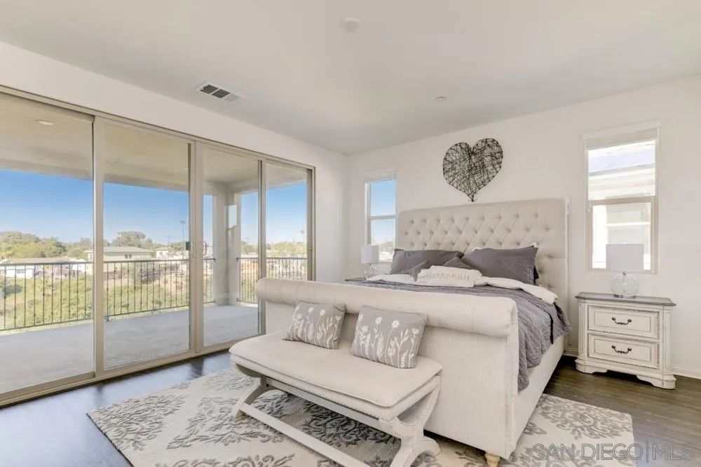 3684 Tavara Circle San Diego, CA 92117 - Photo 17 of 22 a bedroom with a large bed and a window