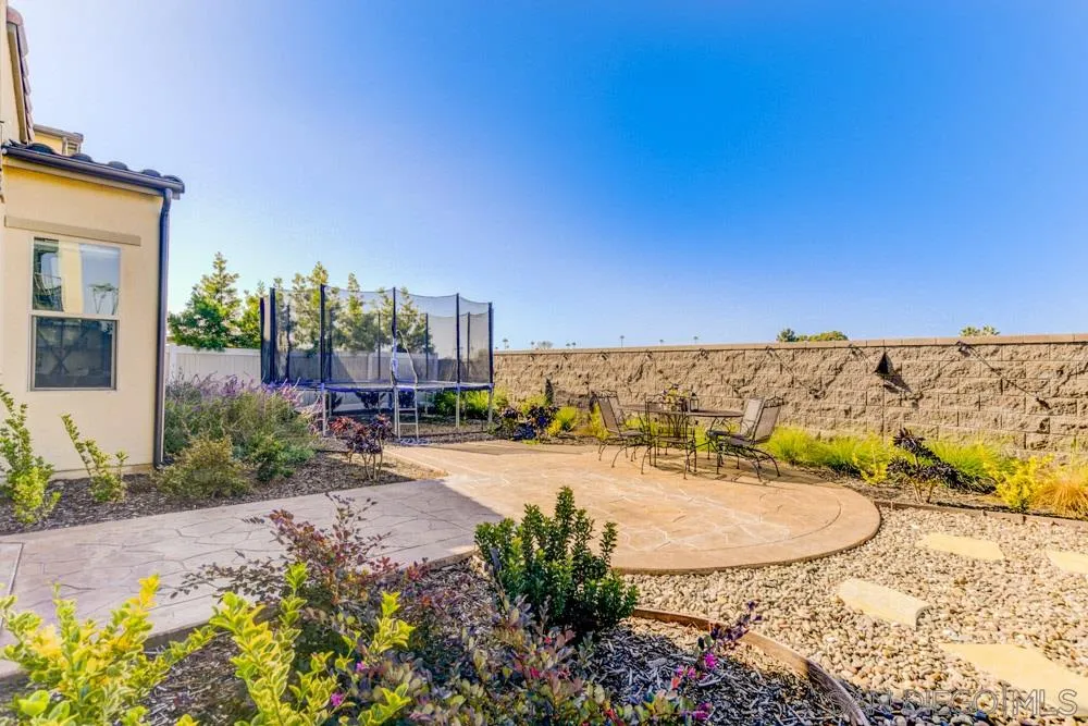 3684 Tavara Circle San Diego, CA 92117 - Photo 22 of 22 a view of a terrace with a garden