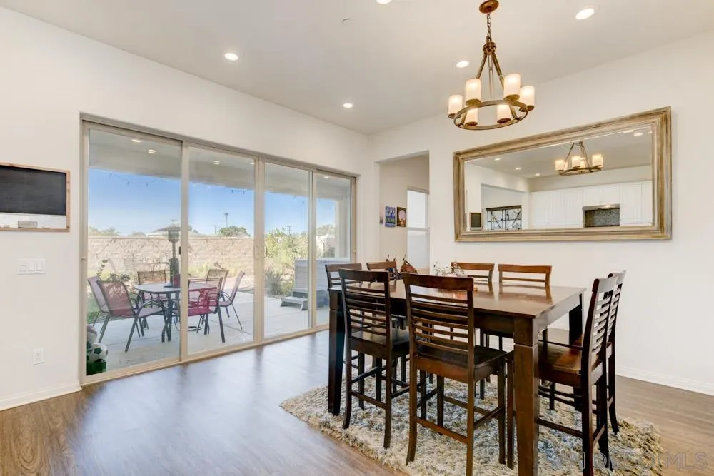 3684 Tavara Circle San Diego, CA 92117 - Photo 5 of 22 a view of a dining room with furniture wooden floor and chandelier