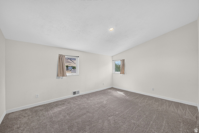 4468 North Droubay Road Tooele, UT 84074 - Photo 20 of 60 Neutral wall finishes, textured carpet flooring, and an angled ceiling