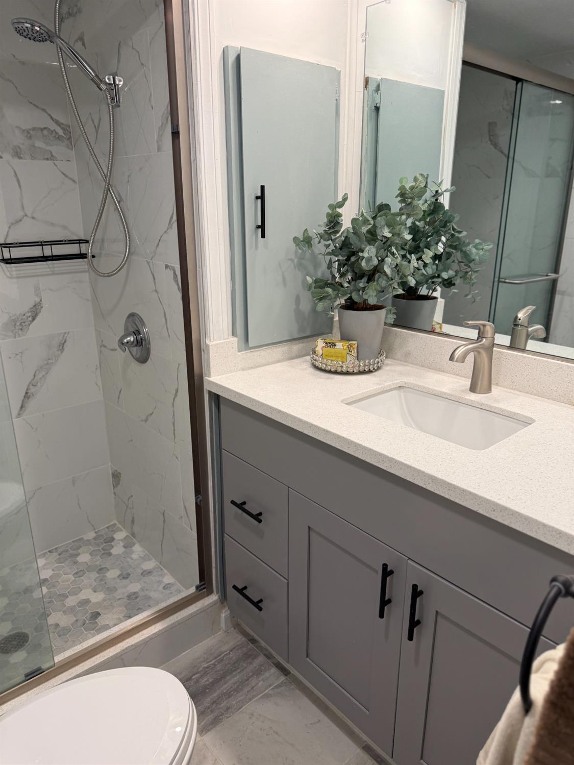10035 Mills Station Road, Unit 16 Sacramento, CA 95827 - Photo 13 of 21 a bathroom with a granite countertop sink toilet a mirror and shower