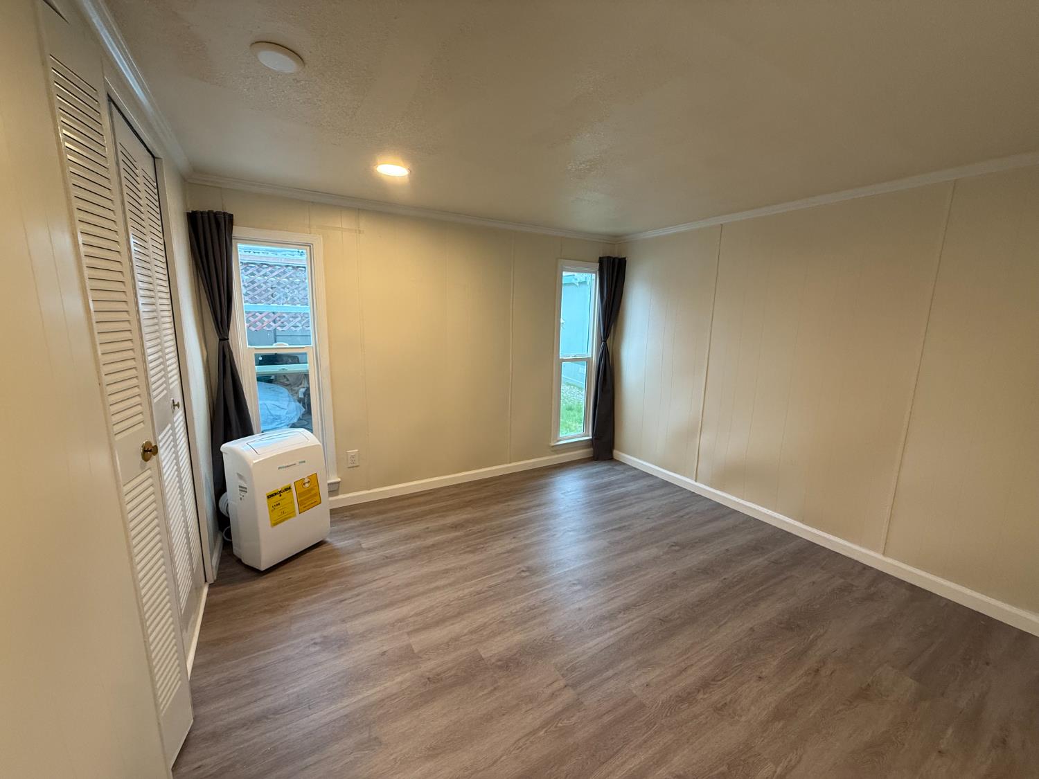 10035 Mills Station Road, Unit 16 Sacramento, CA 95827 - Photo 15 of 21 a view of an empty room and wooden floor
