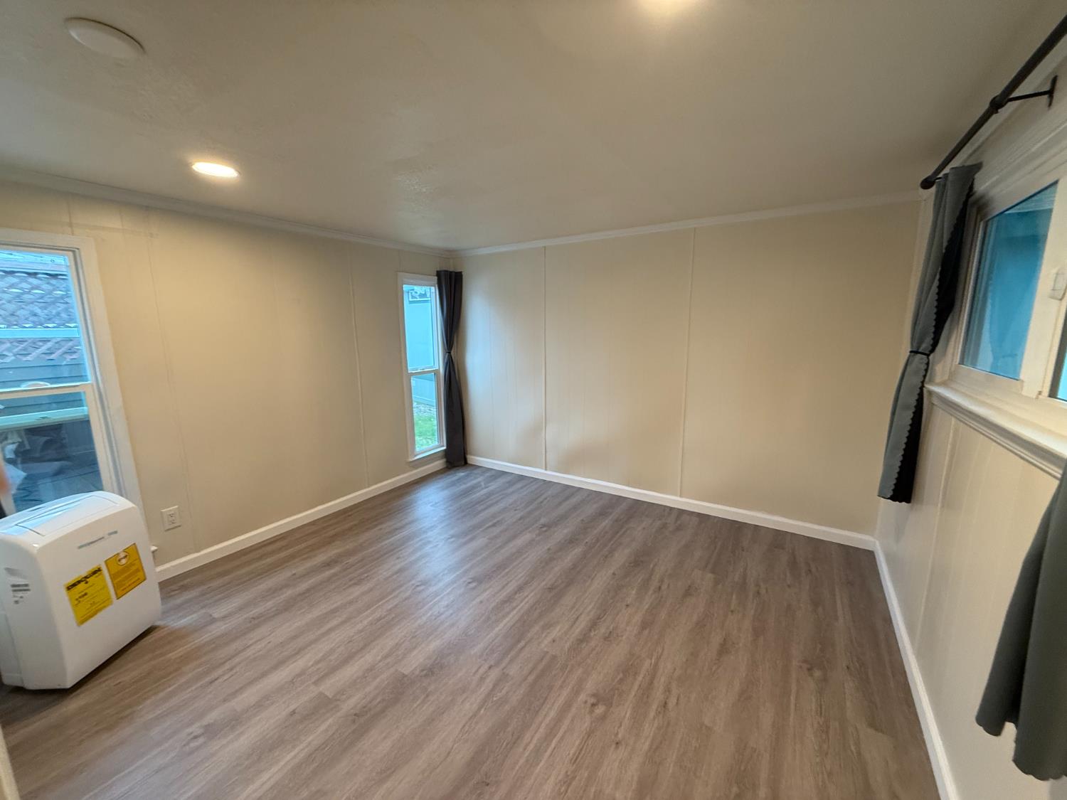 10035 Mills Station Road, Unit 16 Sacramento, CA 95827 - Photo 16 of 21 a view of an empty room with wooden floor and a window