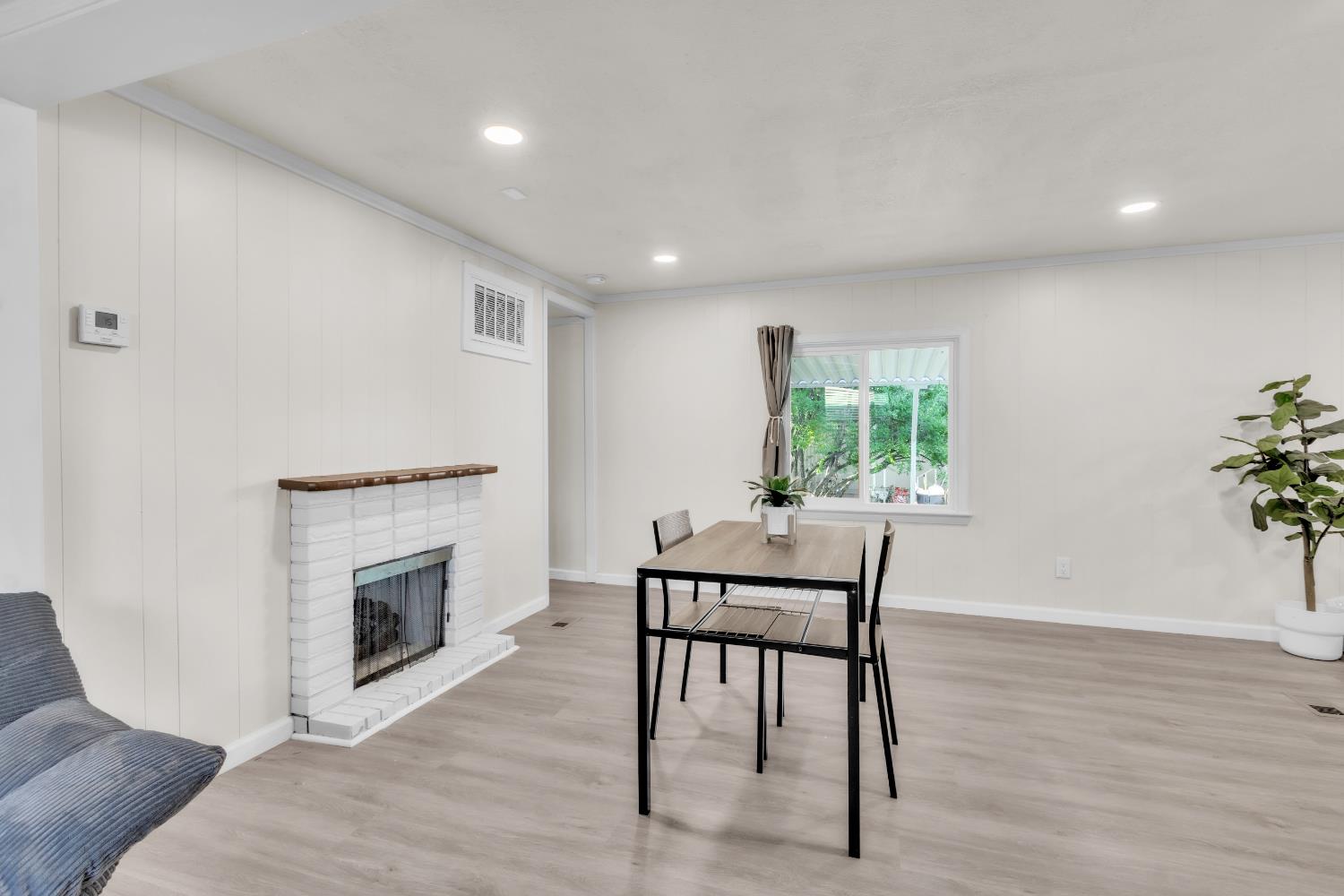 10035 Mills Station Road, Unit 16 Sacramento, CA 95827 - Photo 17 of 27 a living room with furniture and a fireplace