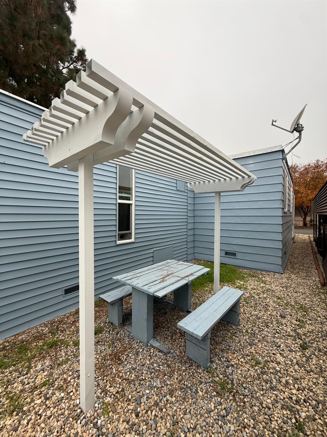 10035 Mills Station Road, Unit 16 Sacramento, CA 95827 - Photo 18 of 21 a view of a patio with table and chairs with wooden floor and fence