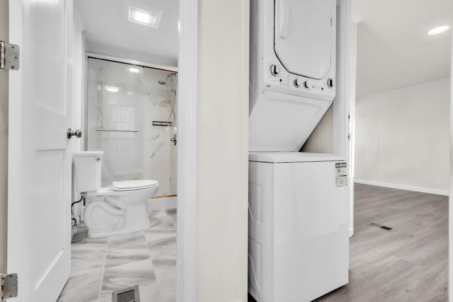 10035 Mills Station Road, Unit 16 Sacramento, CA 95827 - Photo 20 of 27 a bathroom with a granite countertop shower and a toilet